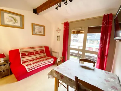 a bedroom with a white bed and a wooden dresser at Morillon 1100: 3 pièces cosy pour 5 pers., balcon sud, à 150m des pistes - FR-1-815-60 in Morillon