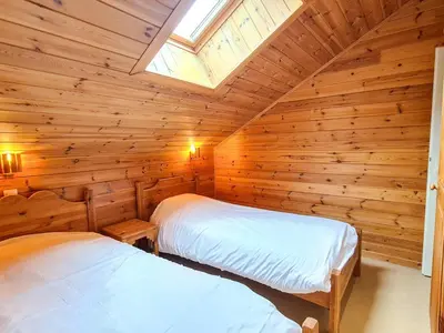 two beds in a log cabin with a skylight at Chalet spacieux 12 pers. à Flaine avec Sauna & Cheminée - FR-1-425-4 in Flaine
