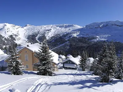 a house in the snow with trees and mountains at Chalet spacieux 12 pers. à Flaine avec Sauna & Cheminée - FR-1-425-4 in Flaine