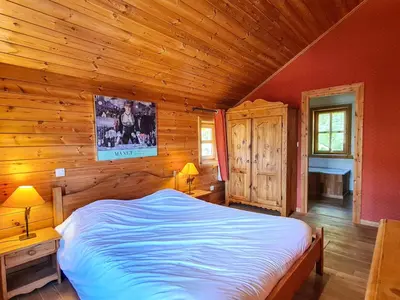 a bedroom with a bed in a log cabin at Chalet spacieux 12 pers. à Flaine avec Sauna & Cheminée - FR-1-425-4 in Flaine