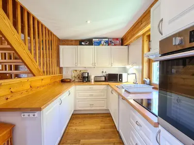 a kitchen with white cabinets and a counter top at Chalet spacieux 12 pers. à Flaine avec Sauna & Cheminée - FR-1-425-4 in Flaine