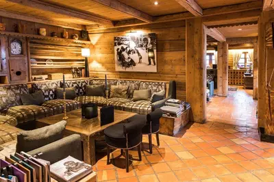 a living room with a couch and a table at Fer à Cheval in Megève