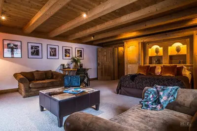a living room with a bed and a couch at Fer à Cheval in Megève