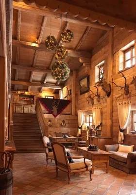 a living room with wooden walls and a staircase at Fer à Cheval in Megève