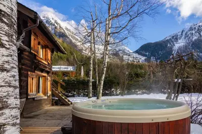 a bench sitting on a deck with a view of a mountain at Mazot les Tines in Chamonix-Mont-Blanc