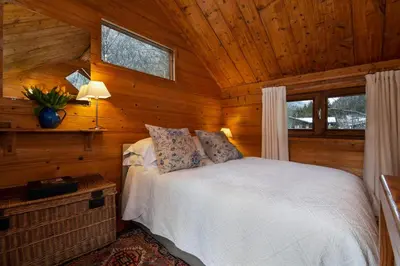 a bedroom with a bed in a log cabin at Mazot les Tines in Chamonix-Mont-Blanc