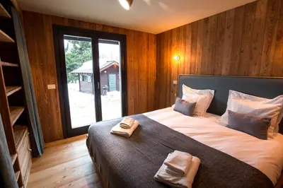 a bedroom with a large bed with two towels on it at Stunning Views Chamonix in Chamonix-Mont-Blanc
