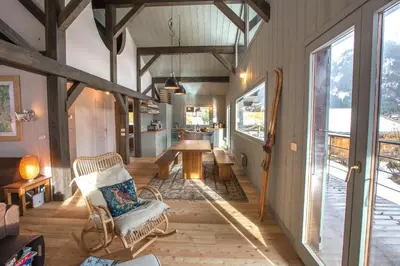 a living room with a table and chairs in a house at Stunning Views Chamonix in Chamonix-Mont-Blanc