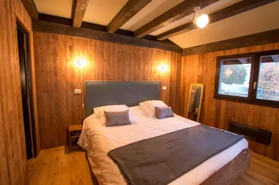 a bedroom with a large bed in a room with wooden walls at Stunning Views Chamonix in Chamonix-Mont-Blanc