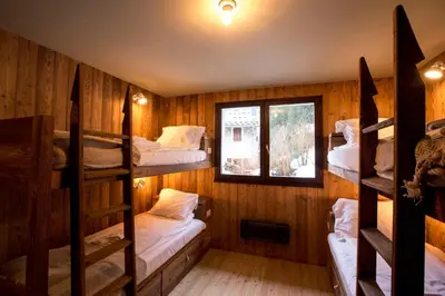 a room with four bunk beds and a window at Stunning Views Chamonix in Chamonix-Mont-Blanc