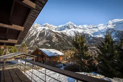 a view of the mountains from the balcony of a house at Stunning Views Chamonix in Chamonix-Mont-Blanc