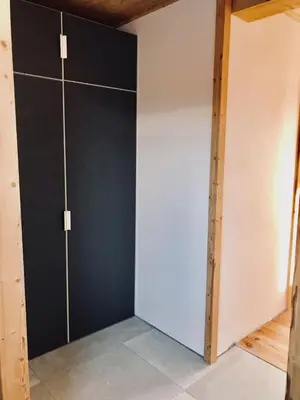 a room with a black and white closet at Chalet Cyclamens, 65m2 plein centre - Jardin, WIFI & parking! in Les Carroz d'Araches