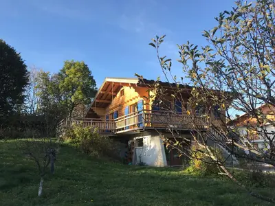 a house with a balcony on the side of it at Chalet Cyclamens, 65m2 plein centre - Jardin, WIFI & parking! in Les Carroz d'Araches