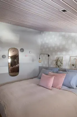 a bedroom with a large bed with a mirror on the wall at Le petit M Chamonix au pied du Brévent in Chamonix-Mont-Blanc