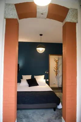a bedroom with a large bed with a blue wall at Appart'Hotel Aiguille Verte & Spa in Chamonix-Mont-Blanc