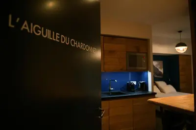a room with a kitchen with a sink and a microwave at Appart'Hotel Aiguille Verte & Spa in Chamonix-Mont-Blanc