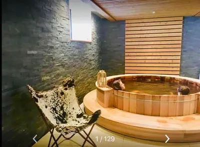 a room with a hot tub and a chair at Appart'Hotel Aiguille Verte & Spa in Chamonix-Mont-Blanc