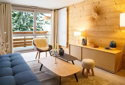a living room with a blue couch and a chair at Luxury appart – Megève – АЕ202 in Megève