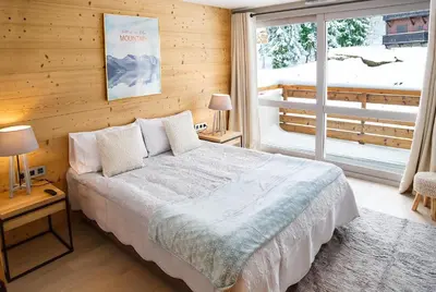 a bedroom with a bed and a large window at Luxury appart – Megève – АЕ202 in Megève