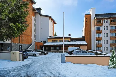 a parking lot with cars parked in the snow at Luxury appart – Megève – АЕ202 in Megève