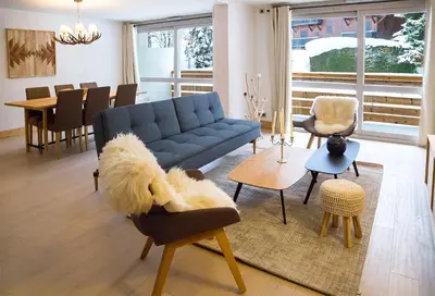 a living room with a blue couch and a table at Luxury appart – Megève – АЕ202 in Megève