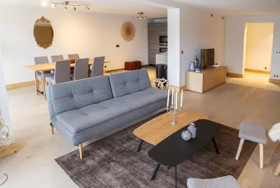 a living room with a couch and a table at Megève appart – 2 bedroms – AW301 in Megève