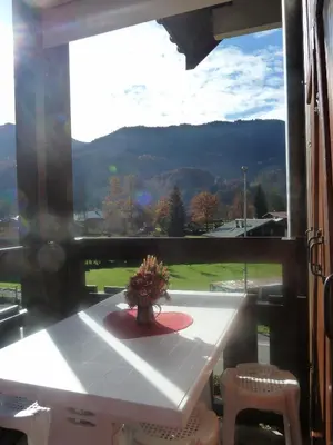 a table and chairs in a room with a window at Samoëns studio in Samoëns