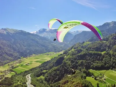 two kites flying in the air over a valley at Samoëns studio in Samoëns
