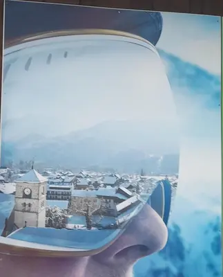 a person holding a wine glass with a clock tower at Samoëns studio in Samoëns