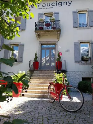 a red bike parked in front of a building at Le Faucigny - Hotel de Charme & SPA in Chamonix-Mont-Blanc