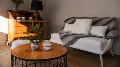 a living room with a couch and a table at Hôtel Arbois Bettex in Saint-Gervais-les-Bains