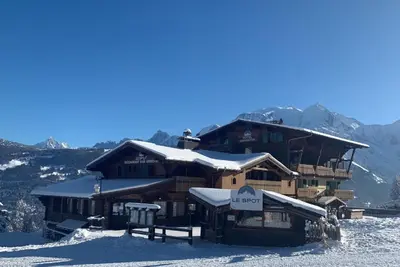 a building on top of a snow covered mountain at Hôtel Arbois Bettex in Saint-Gervais-les-Bains