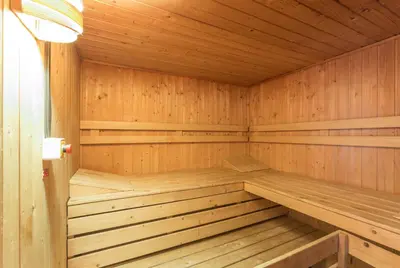 a wooden sauna with a bench in the middle at Résidence Pierre & Vacances Le Mont d'Arbois in Megève