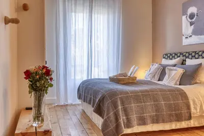 a bedroom with a bed with a vase of flowers at La Féline Blanche Adult Only in Saint-Gervais-les-Bains