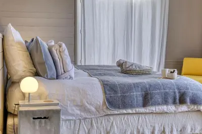 a bedroom with a bed with a blue blanket at La Féline Blanche Adult Only in Saint-Gervais-les-Bains
