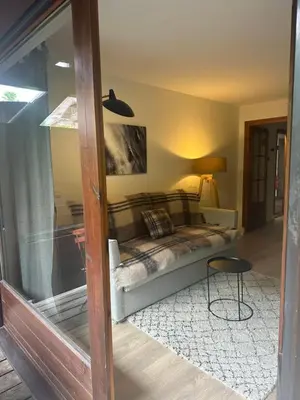 a bedroom with a bed in the corner of a room at La Résidence de L'Ours in Megève