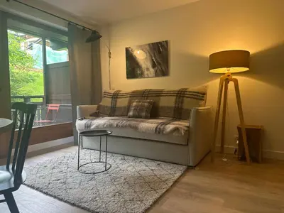 a living room with a couch and a lamp at La Résidence de L'Ours in Megève