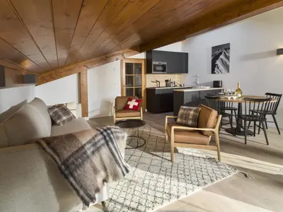 a living room with a couch and chairs and a table at La Résidence de L'Ours in Megève