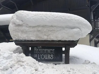 a pile of snow sitting on top of a sign at La Résidence de L'Ours in Megève