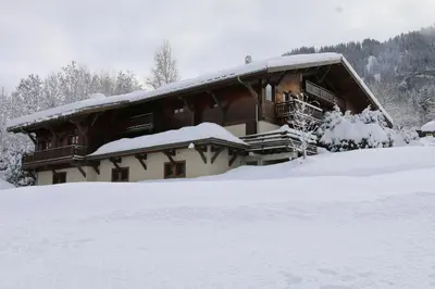 a log cabin in the snow with snow at La Résidence de L'Ours in Megève