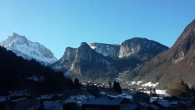 a village in front of a snowy mountain range at Le Bivouac in Sixt