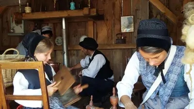 a group of people standing in a kitchen at Le Bivouac in Sixt