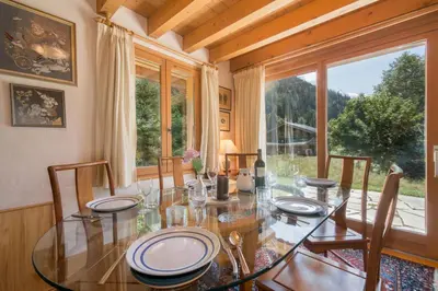 a kitchen with wooden cabinets and a bowl of fruit on the counter at Chalets d'en haut - Zaria - Happy Rentals in Argentiere