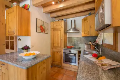 a living room with a table and a chair at Chalets d'en haut - Zaria - Happy Rentals in Argentiere