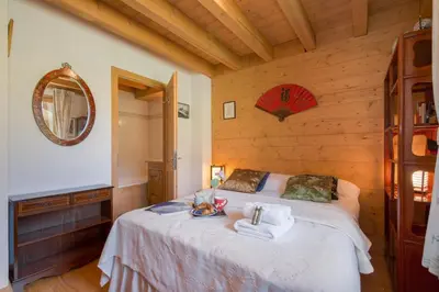 a bedroom with a large bed with towels on it at Chalets d'en haut - Zaria - Happy Rentals in Argentiere