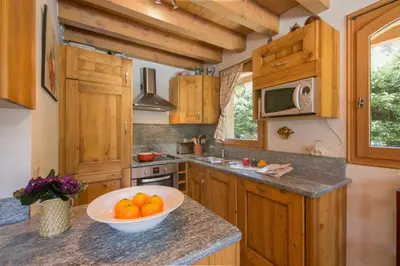 a kitchen with a bowl of oranges on a counter at Chalets d'en haut - Zaria - Happy Rentals in Argentiere