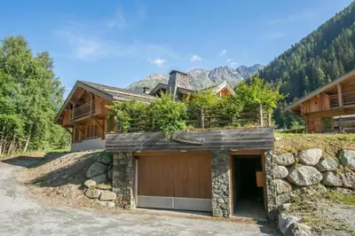 a living room with a couch and a chair at Chalets d'en haut - Zaria - Happy Rentals in Argentiere