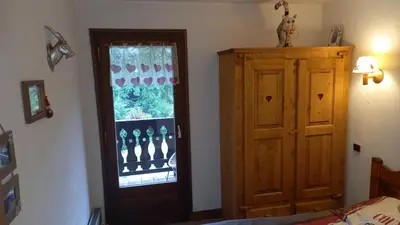 a bedroom with a door and a window at Sallanches 3101 Route de Nant Cruy immeuble le Grand R in Sallanches