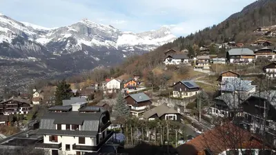 a village in the mountains with snow covered mountains at Appartement Saint Gervais les Bains in Saint-Gervais-les-Bains