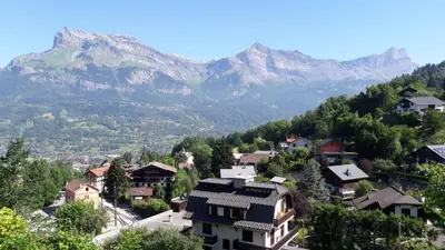 a village in the mountains with mountains in the background at Appartement Saint Gervais les Bains in Saint-Gervais-les-Bains